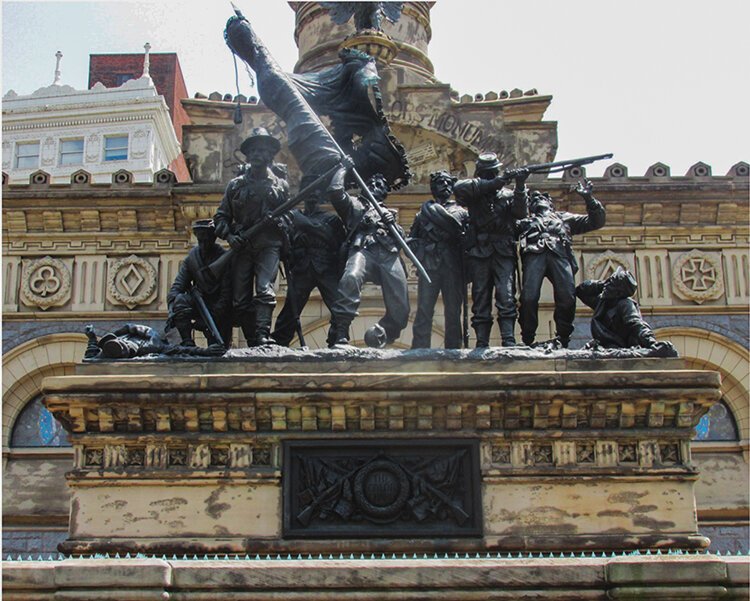 The Infantry Group, “The Color Guard” is situated on the exterior of the Tablet Room in front of the North entrance, centered on the esplanade by sculptor, Levi Scofield -circa 1892.