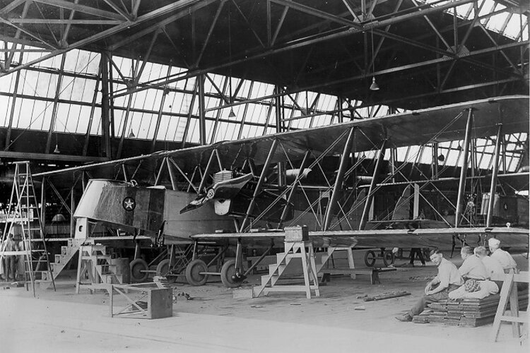 Workers relax after completing work on a Martin Bomber, ca. 1920