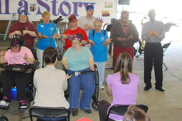 Lisa Ligus leading the Sing & Sign Choir from Southwest Adult Activity Center during the Very Special Arts Festival at the Cuyahoga County Fair Grounds.