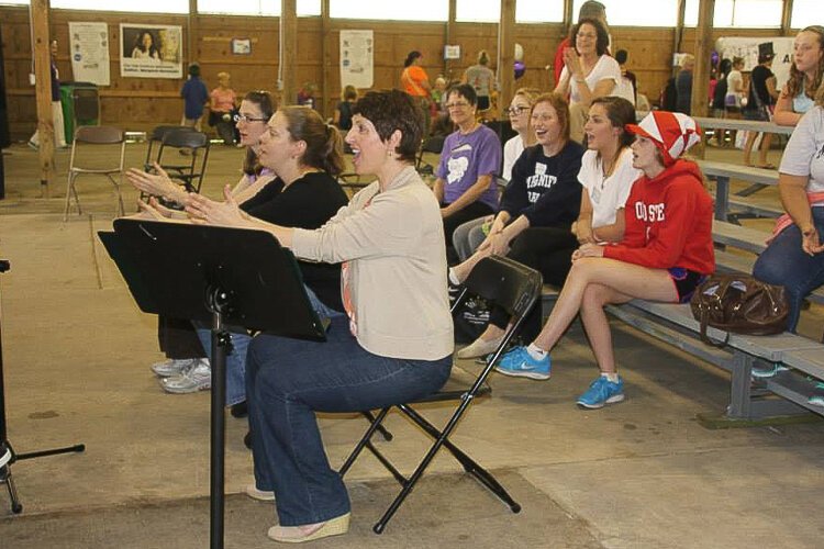 Lisa Ligus leading the Sing & Sign Choir from Southwest Adult Activity Center during the Very Special Arts Festival at the Cuyahoga County Fair Grounds.