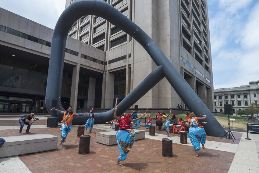 Sculptor Isamu Noguchi, Portal is a thirty-six-foot-tall black tubular steel sculpture outside the Cuyahoga Justice Center that was miked for sound and included a performance with Joe Namy and Djapo Cultural Arts.