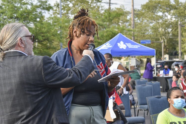 Ashley B., a local childhood advocate who lives in Central, talks about the need for mental health services targeted toward youth in the neighborhood during a community engagement event in mid-August 2021.