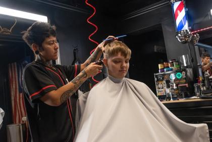 Barber Ariana Perez, owner of Barbercult, cuts the hair of patron Kerstynne Wolchanski at her shop in Lakewood