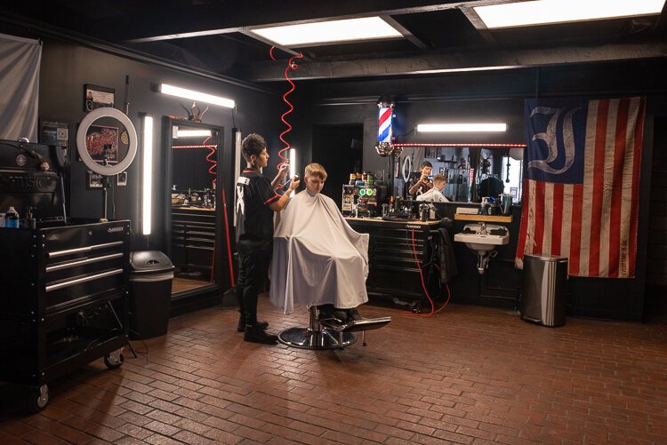 Barber Ariana Perez, owner of Barbercult, cuts the hair of patron Kerstynne Wolchanski at her shop in Lakewood