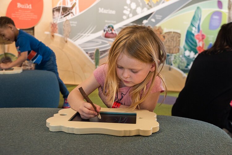 Children can draw their favorite animals at the sketching frames station. 