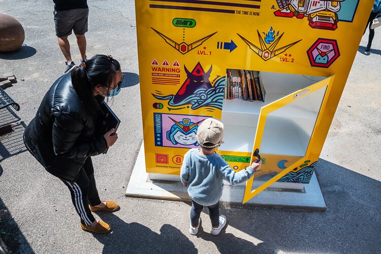 “Super Mega Wonder 1999” a five-feet wide, seven-feet tall, free library adorned with artist Jordan Wong’s renditions of the Japanese Gundam robot kits.