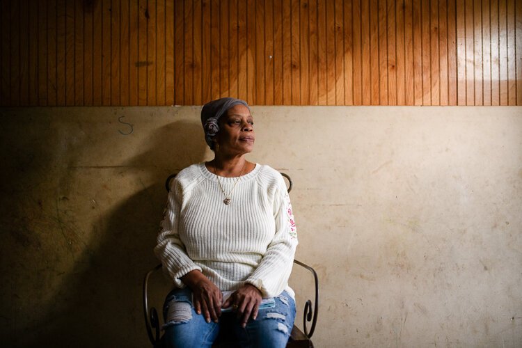 Marguerite Penn sits in her Philadelphia home on Thursday, November 18, 2021. Her mother, who previously owned the house, had accrued $3,000 in water debt before she died in 2010, which has since ballooned to $6,000. The Tiered Assistance Program fro