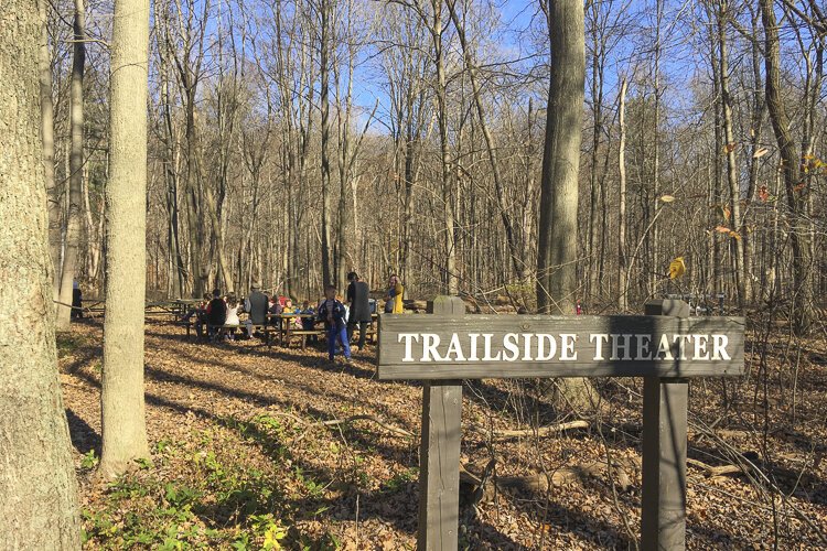 Kids enjoy a bite of lunch in the woods at Trailside Theater.