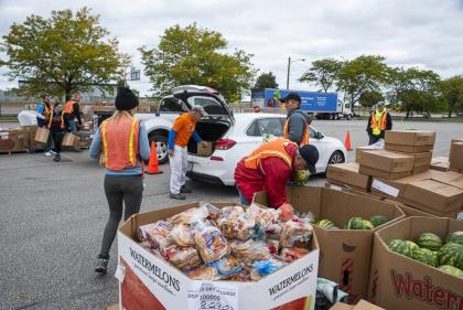 On a typical Thursday, cars line up at Muny Lot for about a mile and an hour to get the Food Bank’s potatoes, watermelons, English muffins, and more.