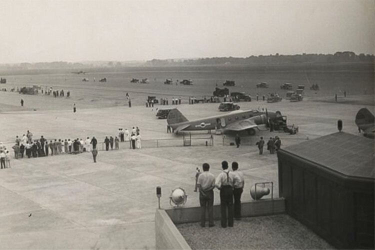 Plane boarding for take-off with people watching at Cleveland Municipal Airport 1930’s