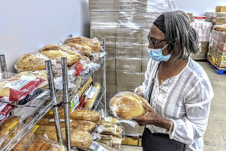 A client picks out bread at the Euclid Neighborhood Pantry