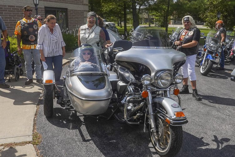Before the ride, the nurses carefully transferred Nora from her wheelchair to the side car, tucking her in for the 15-minute ride.