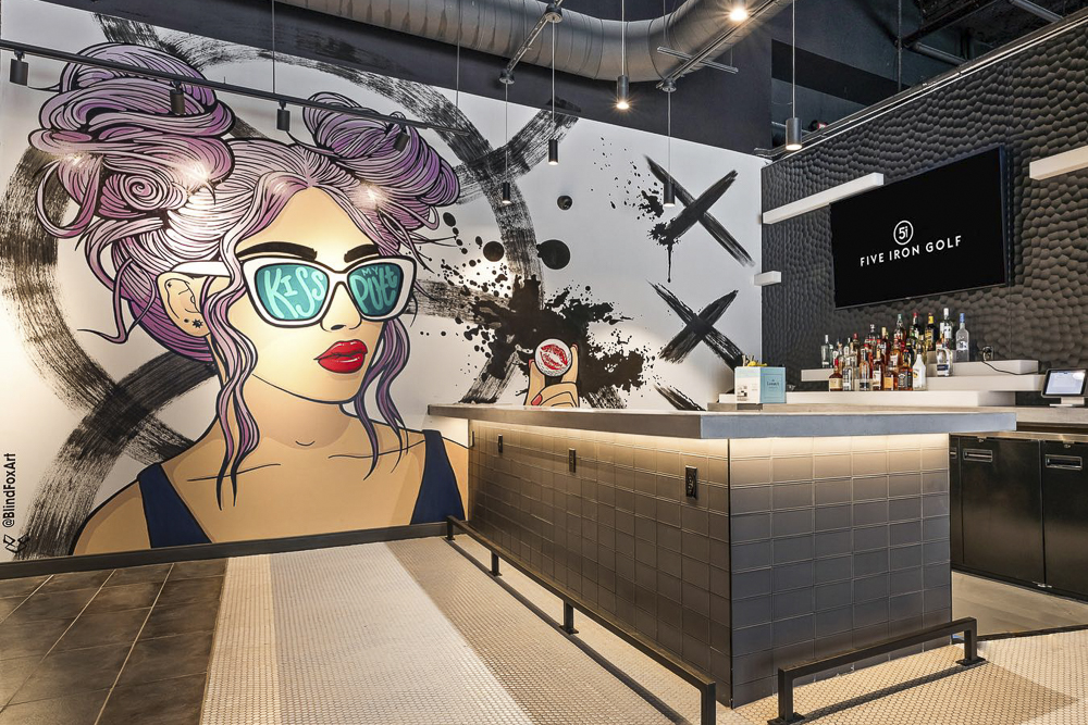 Five Iron Golf on the first floor of the Euclid Grand Apartments