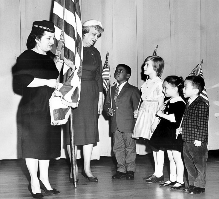 Students at Ludlow Elementary School, including Winston Richie Jr., age 6, (next to the teacher) participate in a program on patriotism in 1962