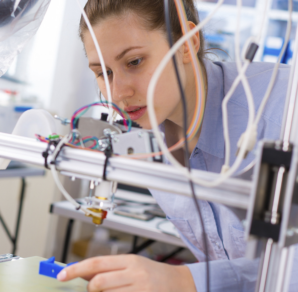 A student girl print prototype on 3D printer