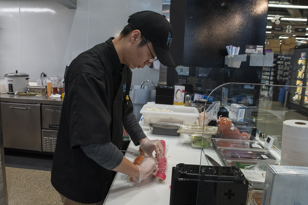Derek Deng of Hissho Sushi prepares sushi at Meijer Fairfax Market