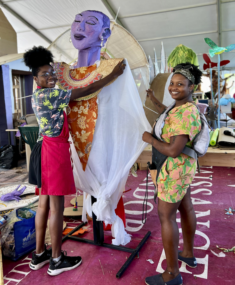 Artists, volunteers, and parade participants putting the final touches on the costumes, puppets, and floats for this year’s Parade the Circle “Visions of Harmony”