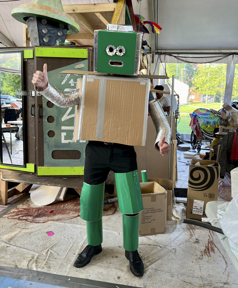 Artists, volunteers, and parade participants putting the final touches on the costumes, puppets, and floats for this year’s Parade the Circle “Visions of Harmony”