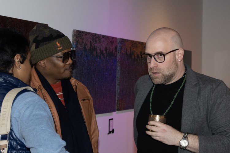 Jason Toth talks to guests during his March gallery opening.