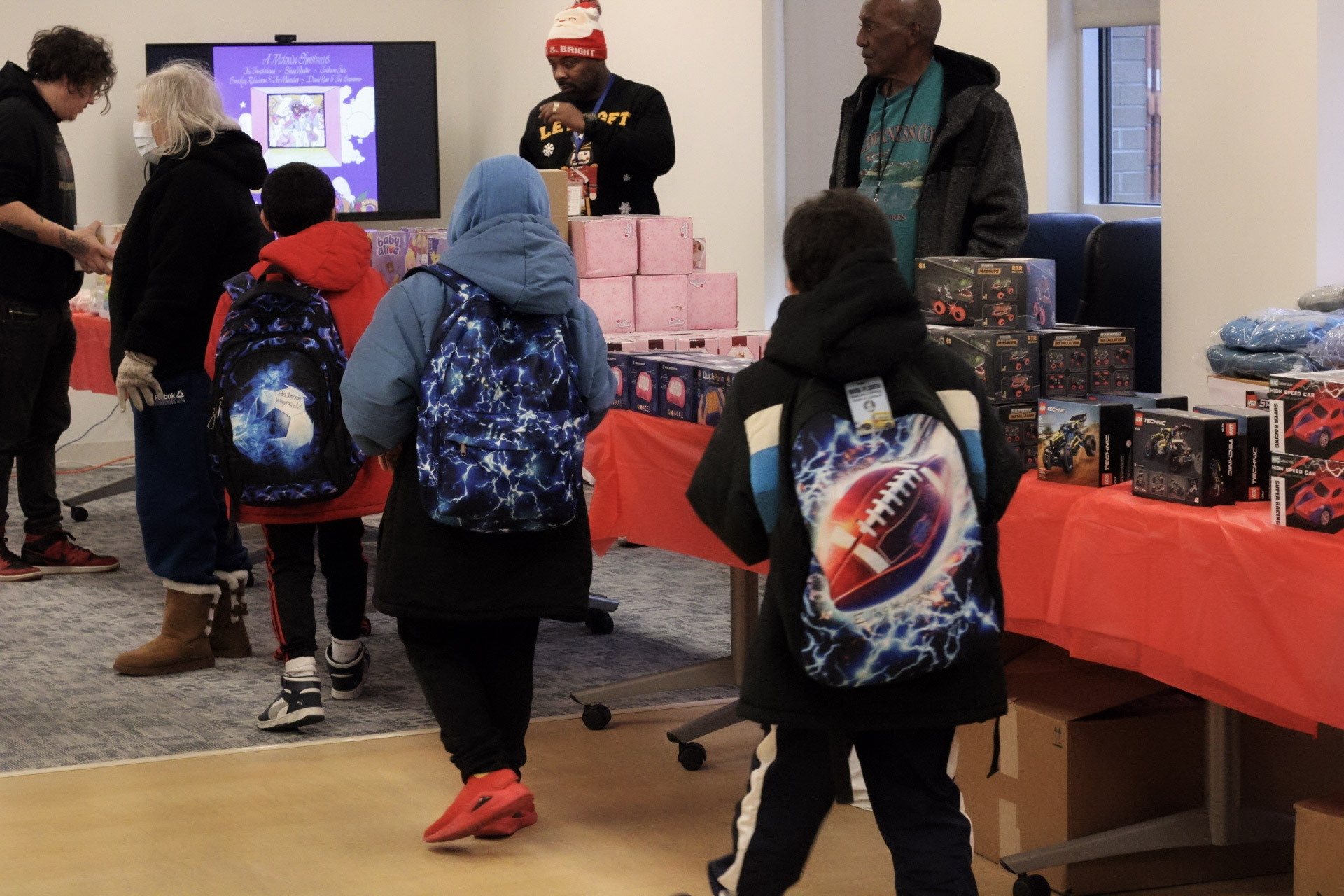 Children choose their gifts as they walk down the toy line.