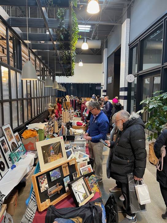 A lively scene from North Union Farmers Market’s indoor Holiday Market, celebrating local creativity and community.