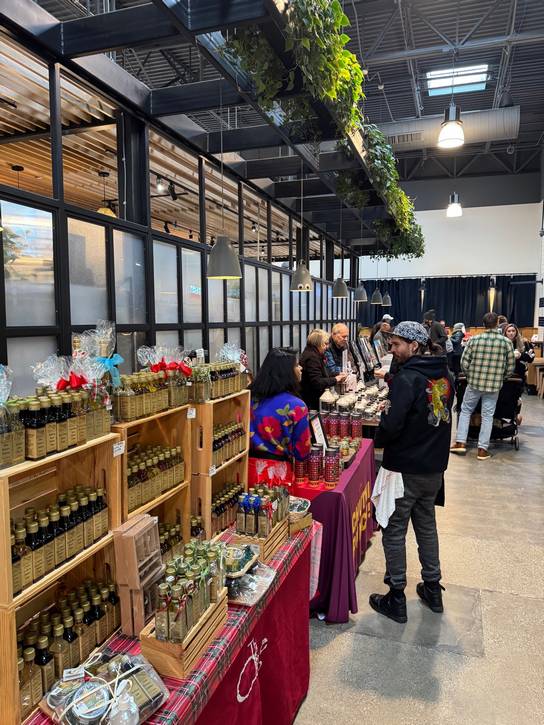 Shoppers explore 35+ local makers and small businesses inside the Market Hall at The Van Aken District.