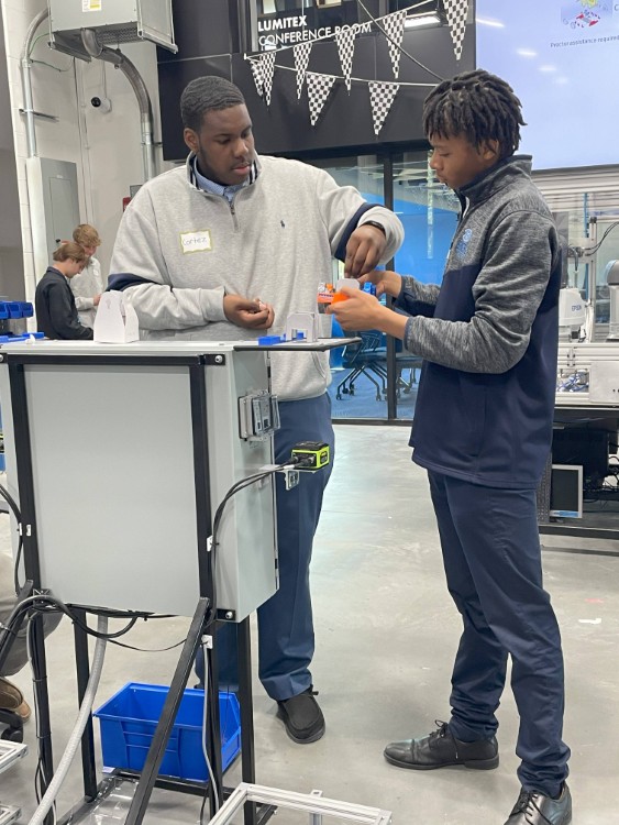 Students from Benedictine High School learn about the manufacturing industry.