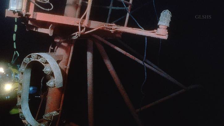 The top of the Fitzgerald’s foremast sees the light for the first time in years during a dive to explore the wreck. The mainmast lies crushed beneath the overturned stern.