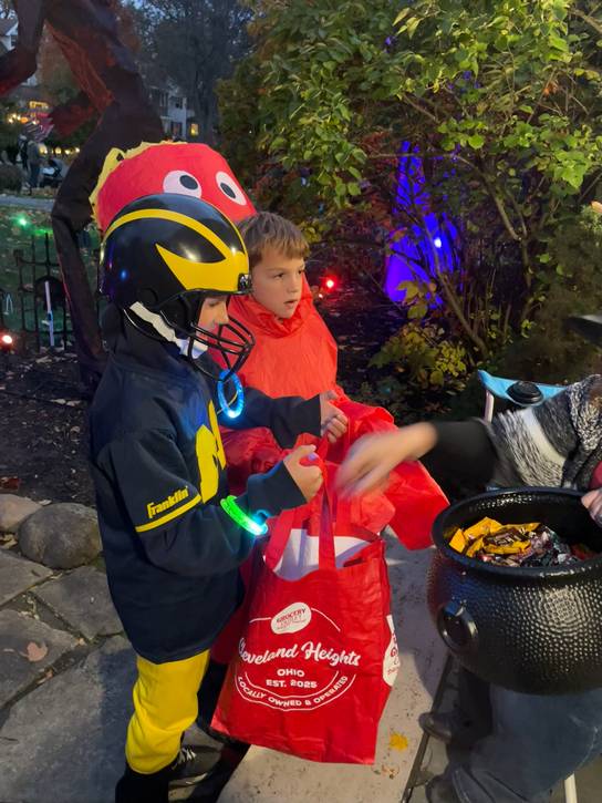 Football player and air dancer trick or treat.