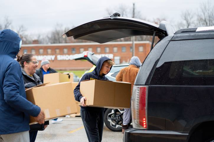 Volunteers with Catholic Charities, Diocese of Cleveland deliver turkey dinners on Thanksgiving.