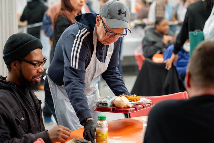 Volunteers serve Thanksgiving dinner at St. Augustine Hunger Center.