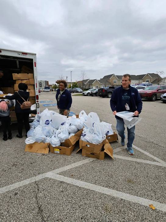 Care Alliance volunteers bring the turkey bags outside for pickup.
