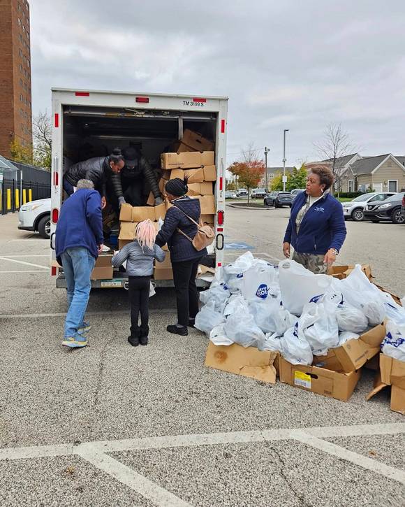 Care Alliance volunteers bring the turkey bags outside for pickup.