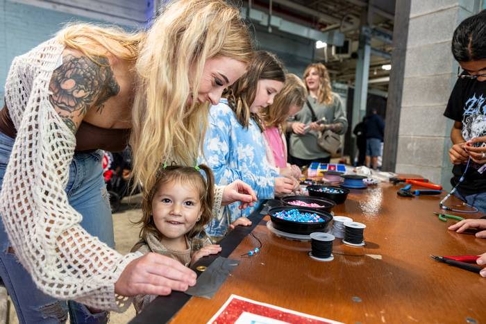 Kids beading craft at  2024 Ingenuity Fest.
