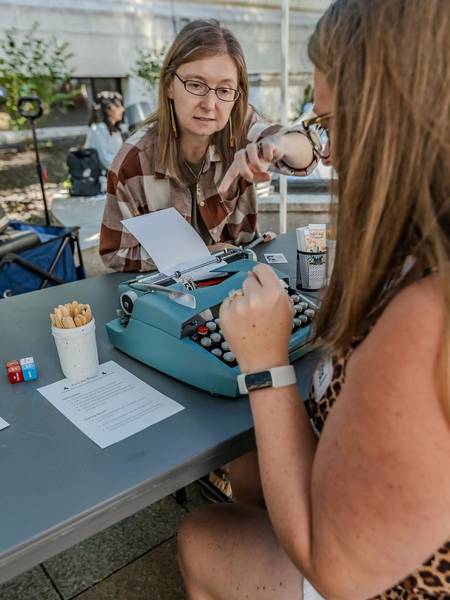 Inkubator attendees work on a typewriter.
