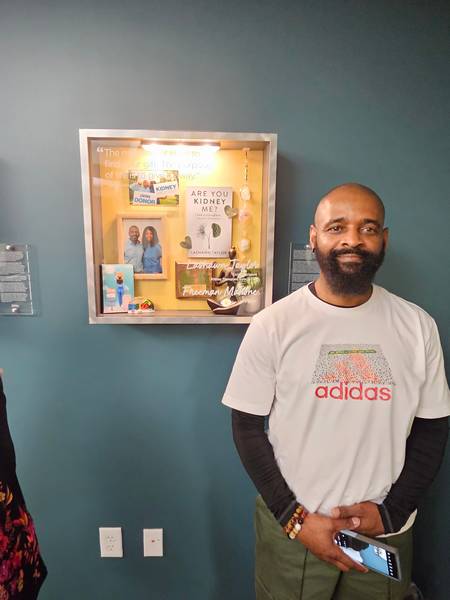 Freeman Mahone in front of their shadow box.