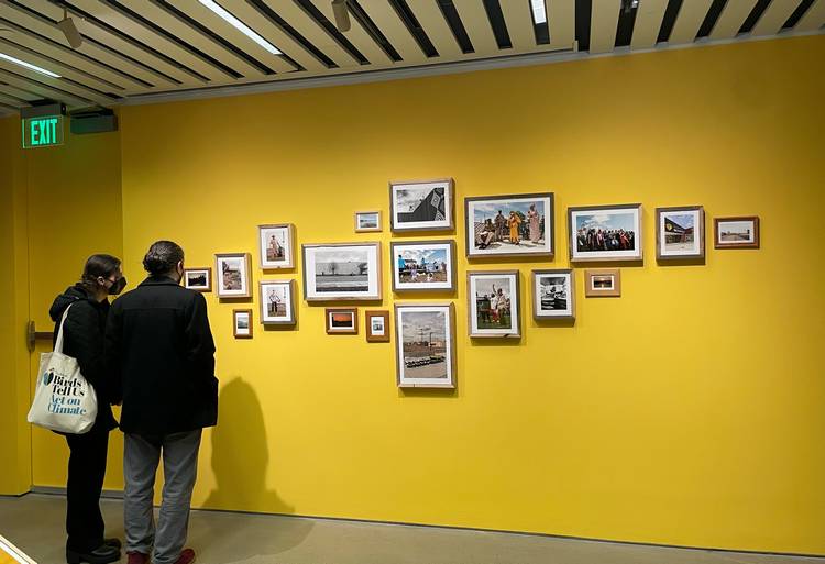 Guests look at a selection of photos during moCa Cleveland's 2026 season opening event.