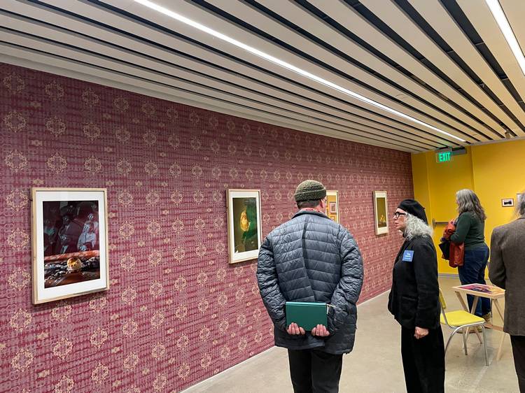 Guests look at a selection of photos during moCa Cleveland's 2026 season opening event.