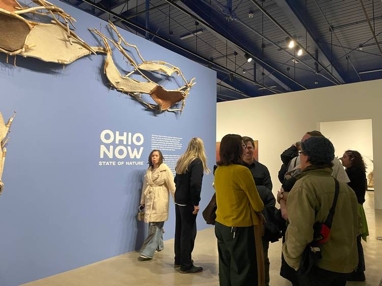Guests mingle in front of the 'Ohio NOW: State of Nature" photo exhibit at moCa Cleveland's 2026 season opening event.