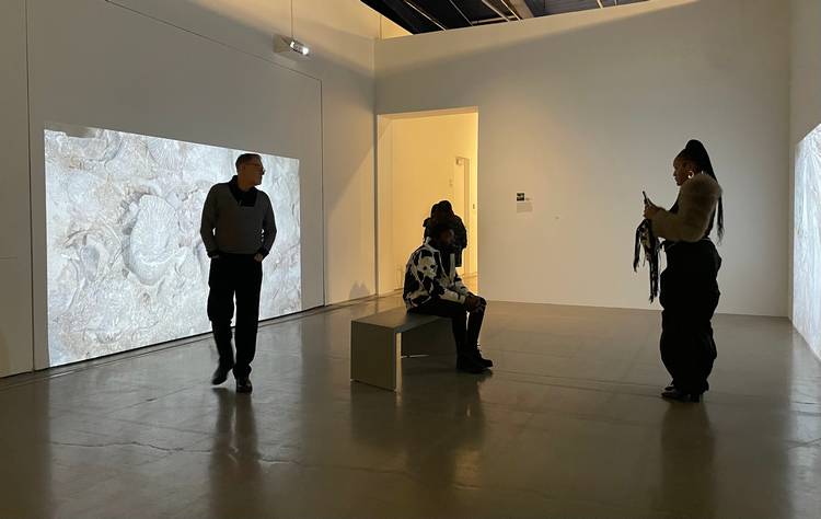 Guests mingle and study the four exhibits at moCa's recent 2026 season opening event.