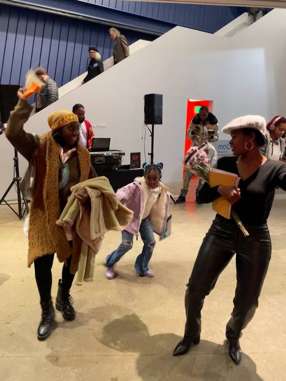 Pausing to enjoy DJ Silk at Visitors study the work of Akron artist Avery Mags Duff at moCa Cleveland's 2026 season opening event..