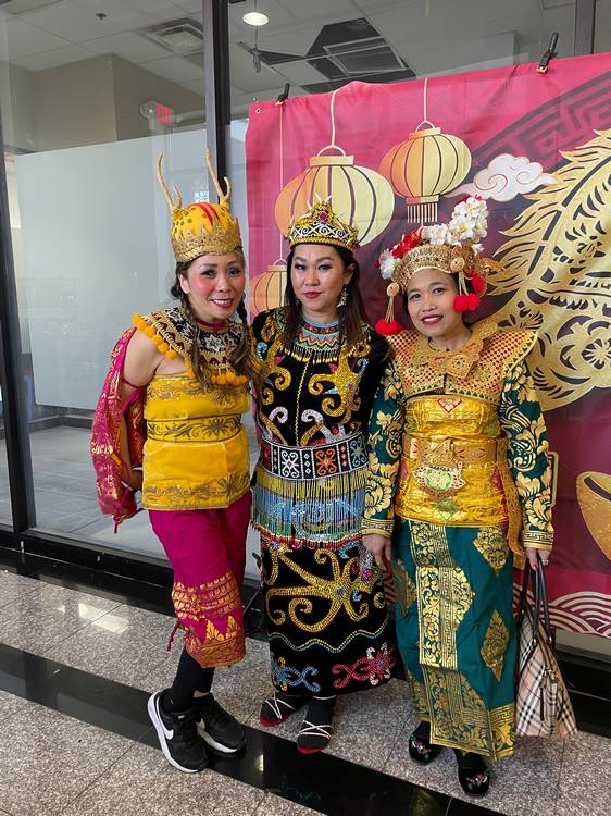 Three women in authentic dress at the 2026 Lunar New Year celebration in AsiaTown.