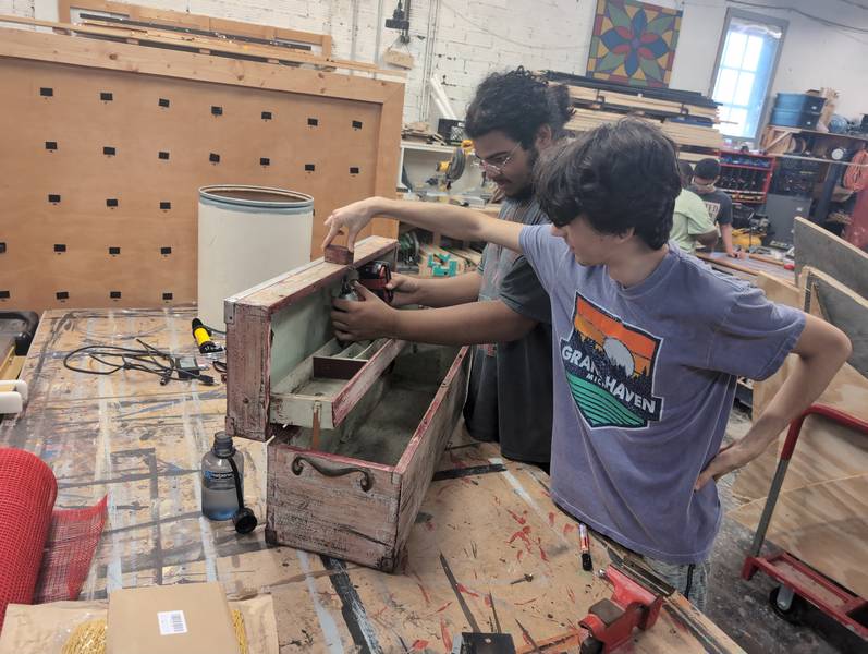 STEP participants inspect a tool box.