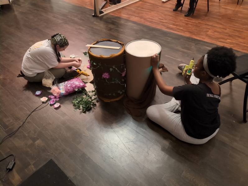 The technical theater crew members build sets.