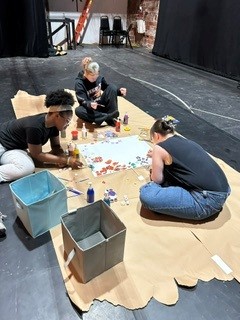 The technical theater crew members build sets.
