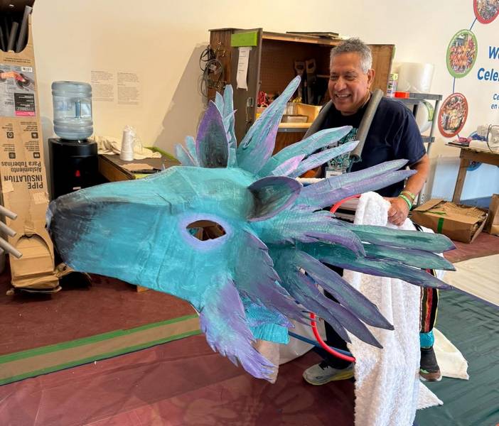 Héctor Castellanos Lara shows off a giant puppet head.