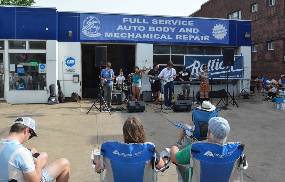Rellick performing at the Shaker Quality mechanic shop.