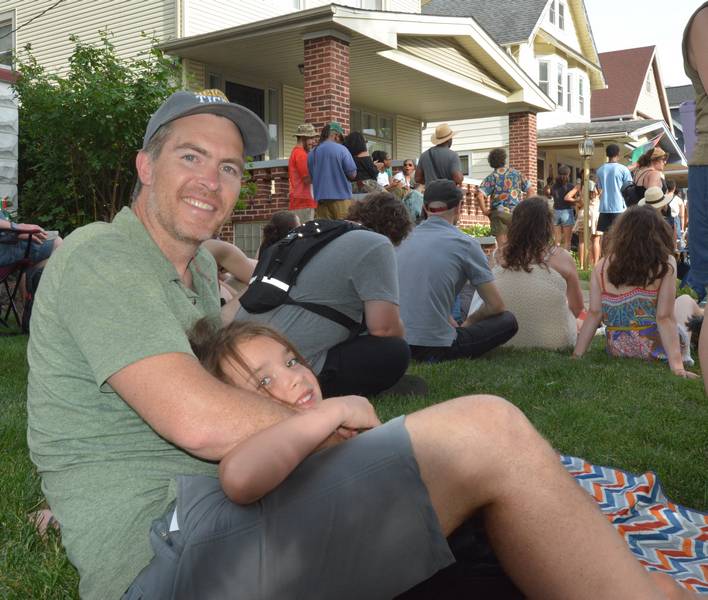 Cleveland Heights City Council member Joe Dewitt-Foy and his daughter enjoying the music in the sunshine.