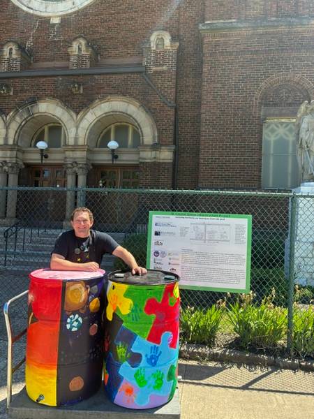 Willson visual arts teacher Adam Nunnari shows off some of St. Casimir's completed rain barrels.