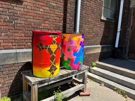 Left, depicting love of faith combined with the infinite universe. Right, middle schoolers painted puzzle pieces while the fist grade classroom printed their hands in fluorescents.